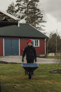 Woman pushing wheelbarrow