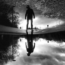 Reflection of man in water