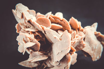 Close-up of bread on table against black background