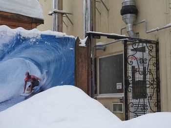 Rear view of man working on frozen building