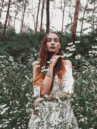 Portrait of beautiful young woman in forest