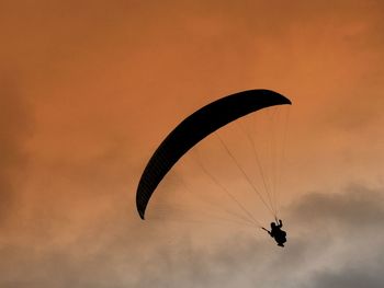 Rear view of parachuting against the sky