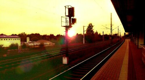 Railway station platform against clear sky during sunrise