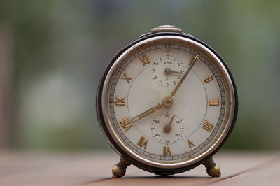 Close-up of clock on table