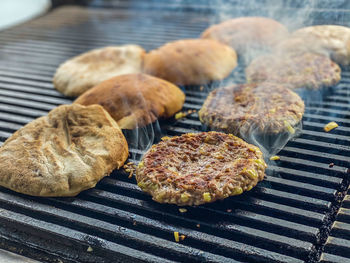 High angle view of meat on barbecue grill