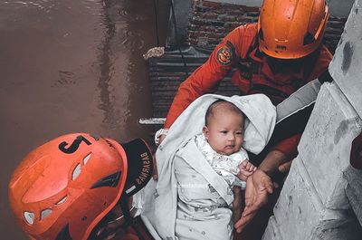 High angle view of cute baby amidst buildings