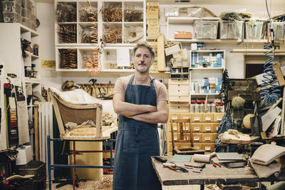 Portrait of young man standing at store