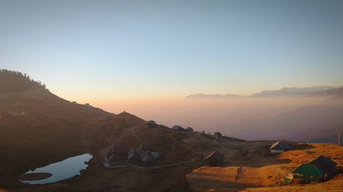 Scenic view of mountains against clear sky during sunset