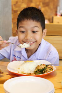 Portrait of boy sitting on table