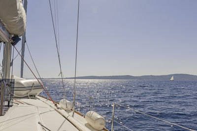 Sailboats sailing on sea against sky