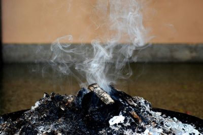 Close-up of smoke emitting from rock