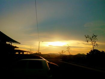 Car on road against sky during sunset