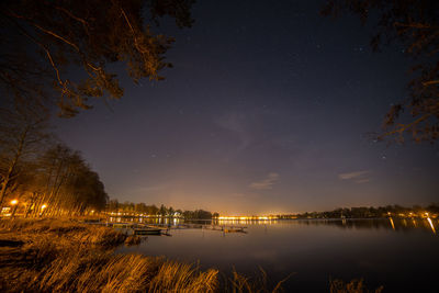 Reflection of trees in water at night