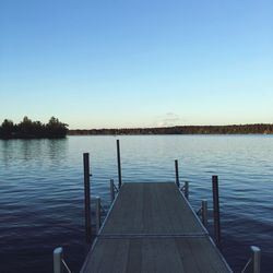 Pier on lake against clear sky