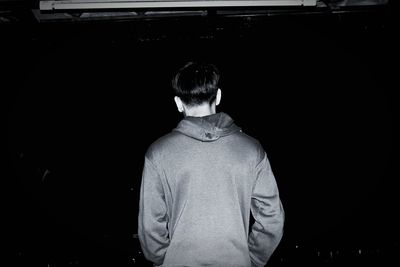 Rear view of man standing at night