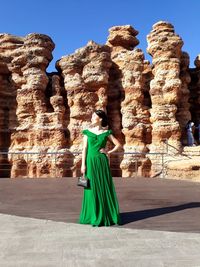 Woman standing against rock formations