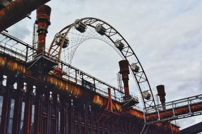 Low angle view of rollercoaster against sky