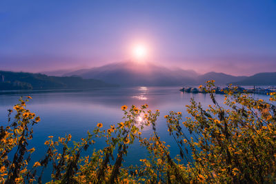 Scenic view of lake against sky during sunset