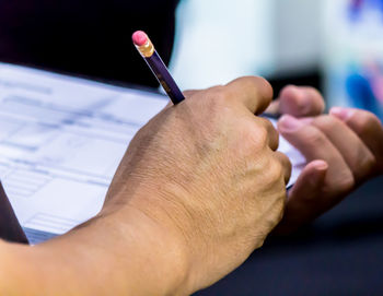 Close-up of man hand filling form