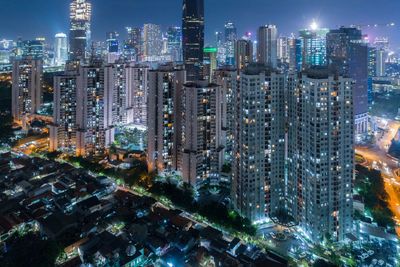 Aerial view of illuminated buildings in city at night