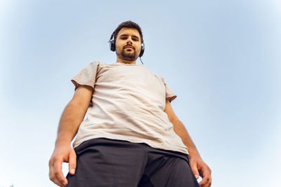 Low angle view of man standing against clear sky