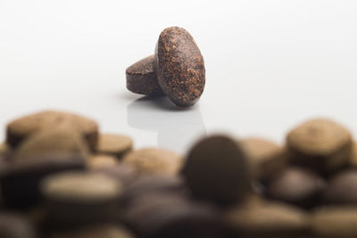 Close-up of chocolate cake on table against white background