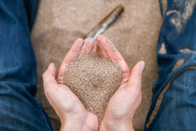 Midsection of person playing with sand