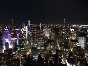 High angle view of illuminated buildings in city at night