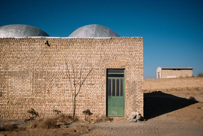 Exterior of old building against clear blue sky