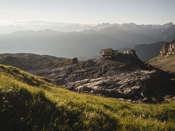 View of house on landscape against mountain range