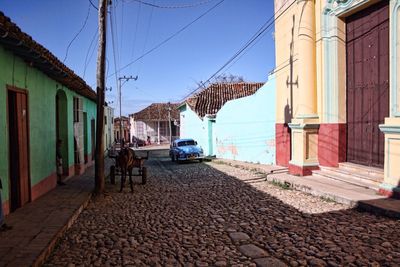 Empty road with buildings in background