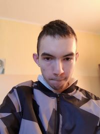 Portrait of young man against wall