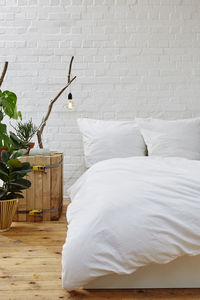 White image of bed on wall at home