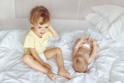 High angle view of young woman lying on bed at home