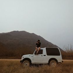 Man standing on field against sky