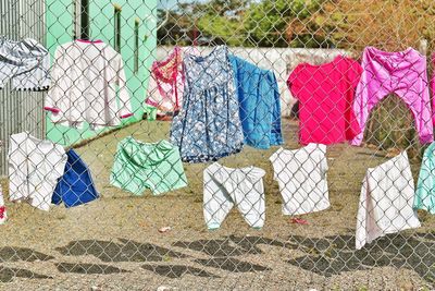 Clothes hanging on chainlink fence