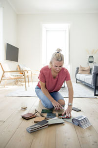 Woman looking at swatches on floor