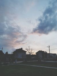 Silhouette buildings against sky at sunset