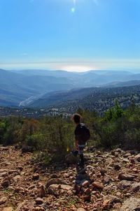 Man standing on mountain against sky