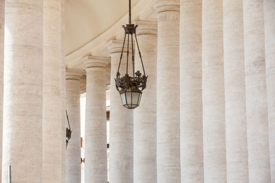 Detail of the beautirul doric colonnade at st. peter square on the vatican city in rome