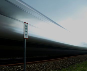 Information sign against sky