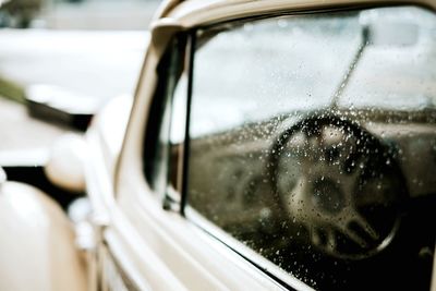 Close-up of reflection of car on side-view mirror