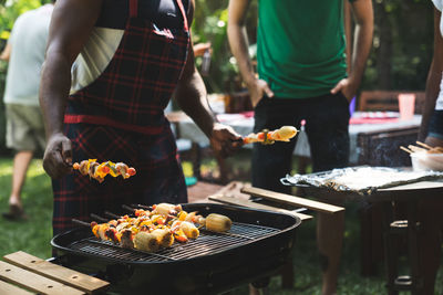 Man preparing food on barbecue grill