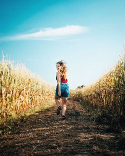 Full length of woman running on field