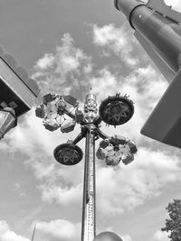 Low angle view of chain swing ride against sky