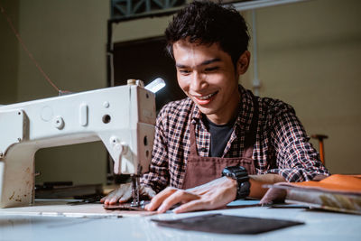 Portrait of young man working at table