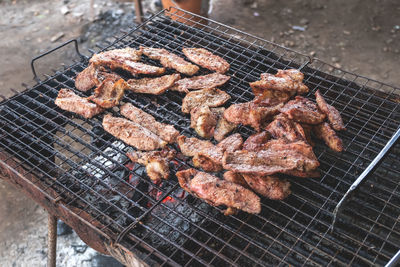 High angle view of meat on barbecue grill