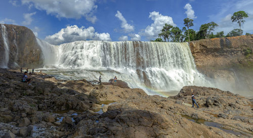 Scenic view of waterfall against rocks