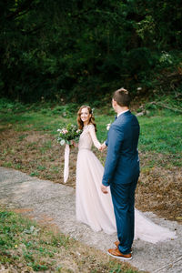 Portrait of bride standing on field