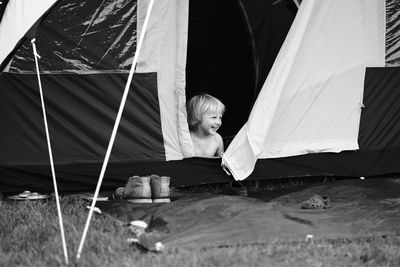 Boy sitting at tent